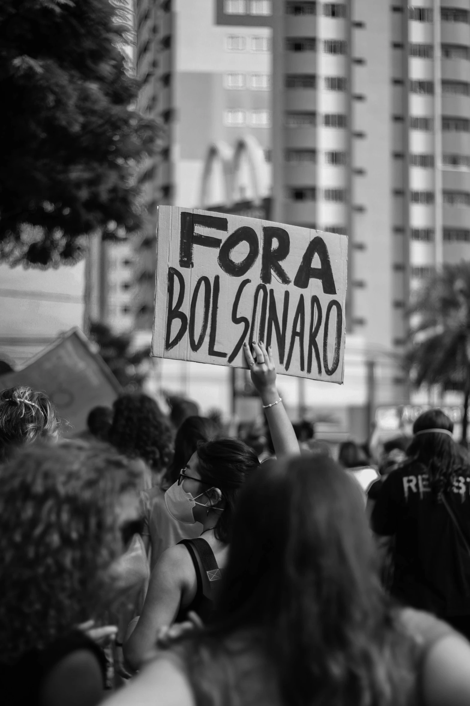 a sign is held high in a crowd