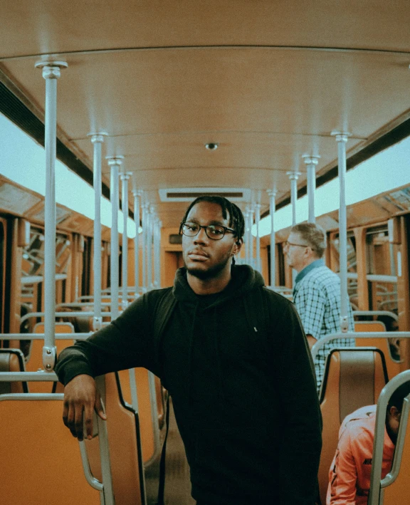 a man standing on a subway in a train