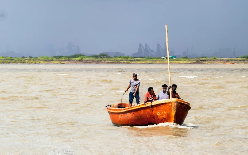 a group of people are in the water on a small boat