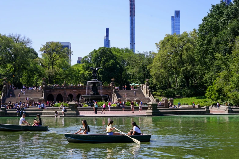 people sitting in small boats on a river