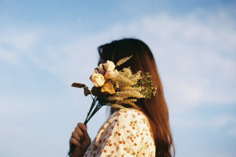 the back of a woman's head with flowers in her hair