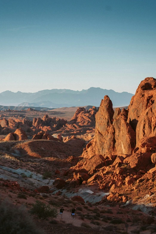 a dirt area with mountains in the background