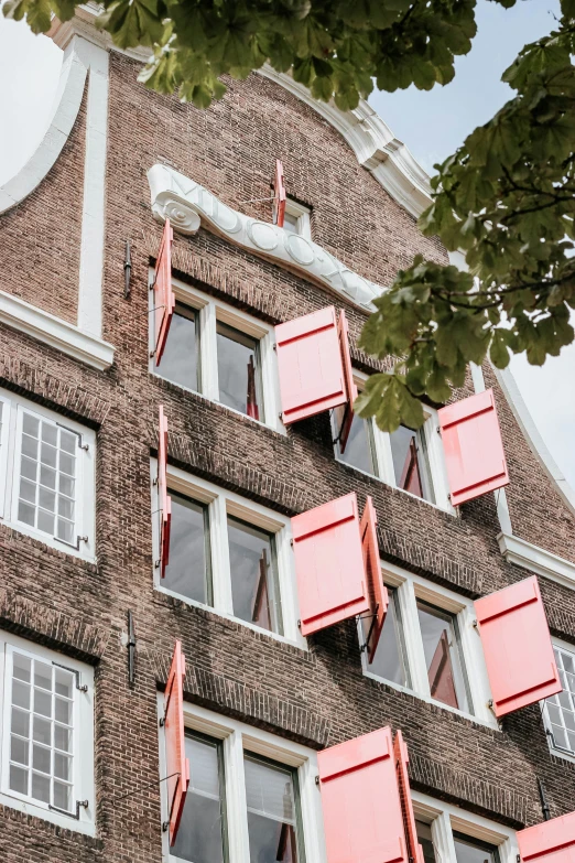 red shutters are on the side of a building