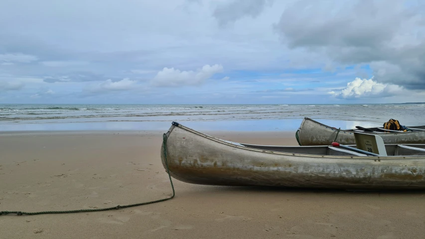 two canoes that are on the beach