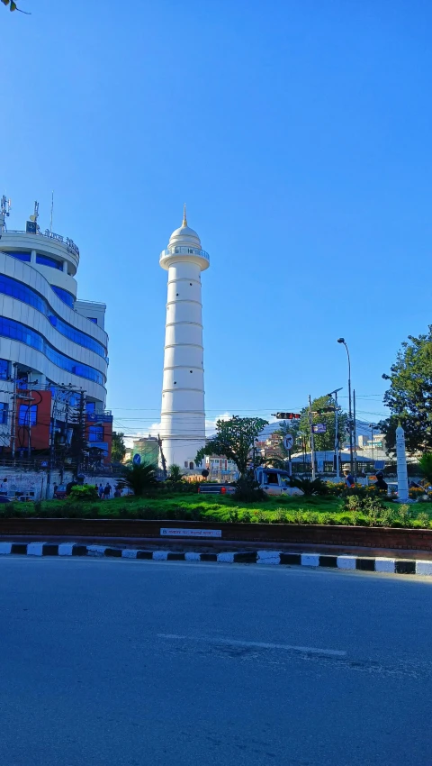 two tall white towers in front of a building