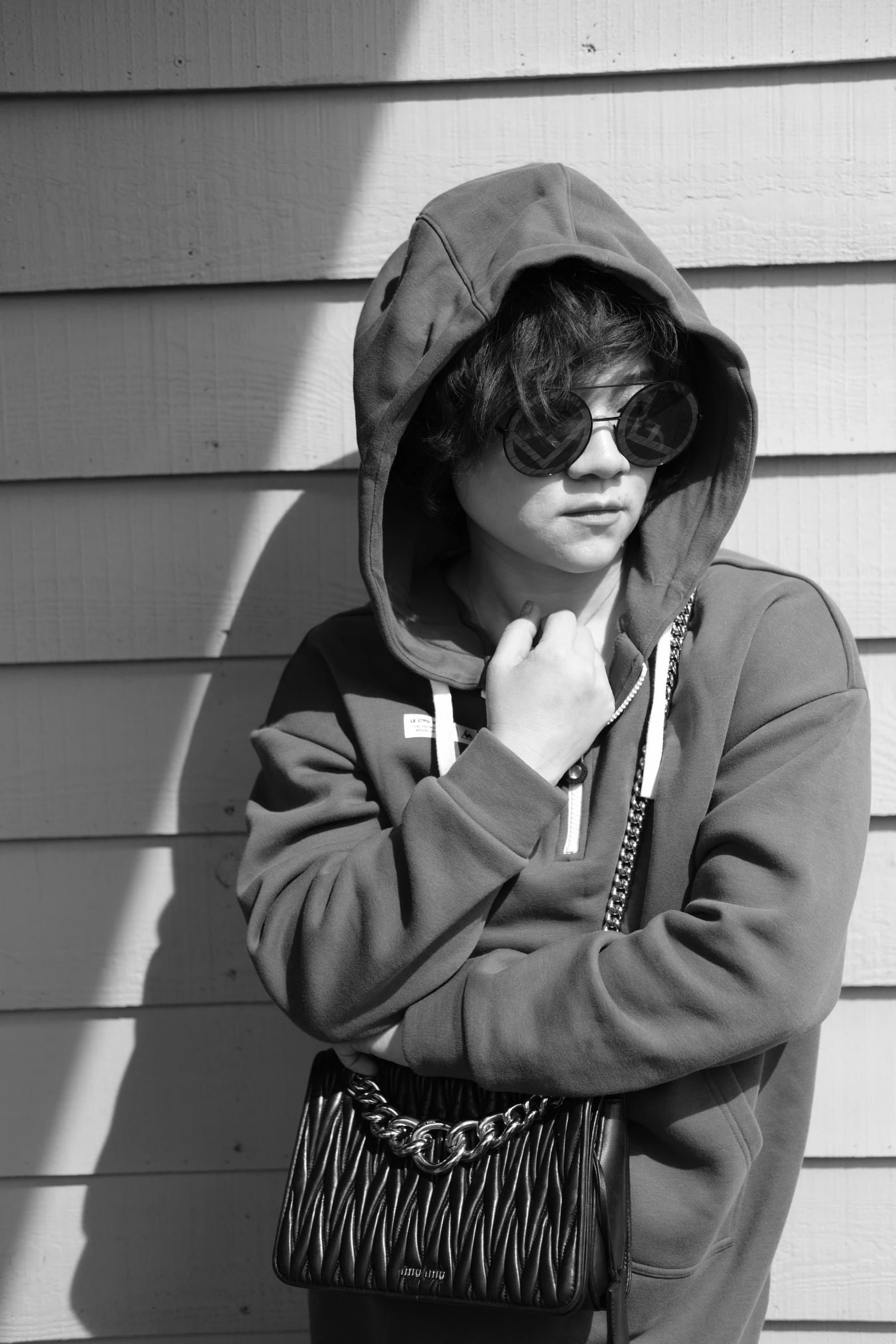 black and white po of person in hoodie standing
