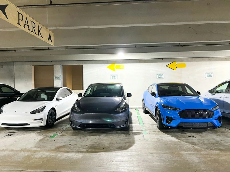 several cars in parking garage on a cold evening
