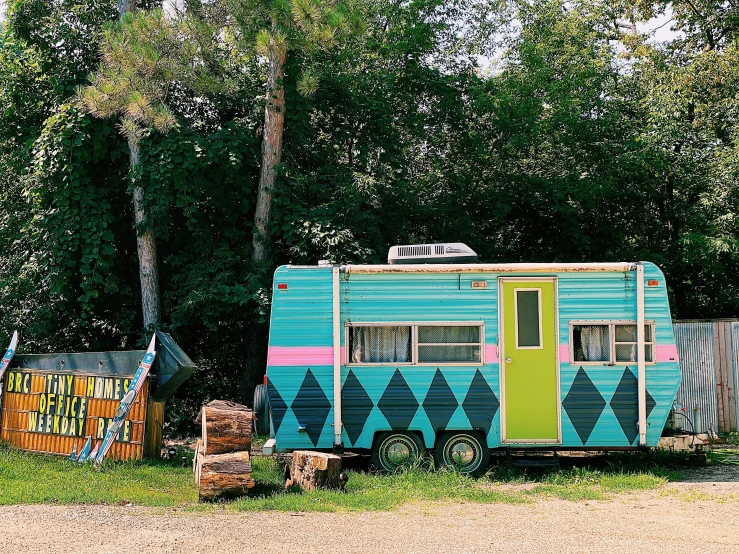 a trailer sitting in front of some woods