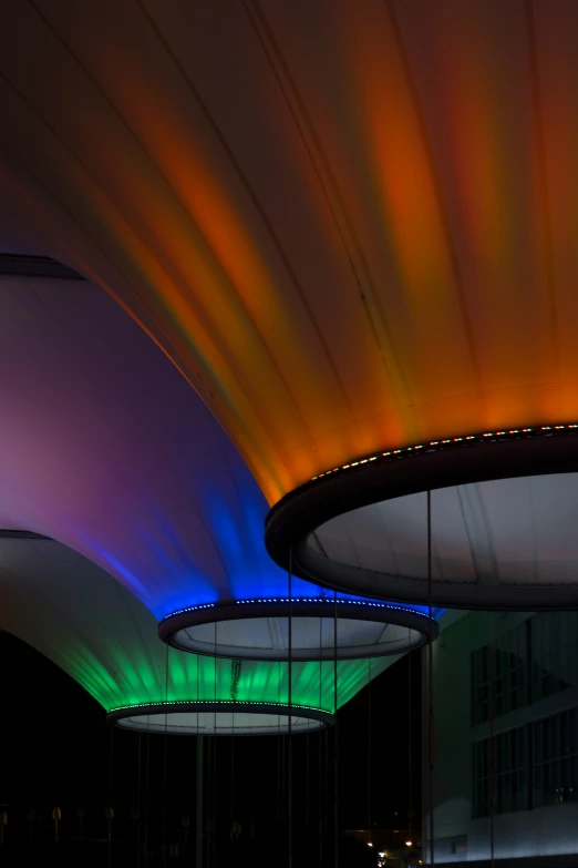 the lighting is colorful in the dark above some buildings