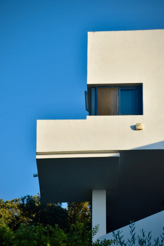 an orange bird sitting on top of the building