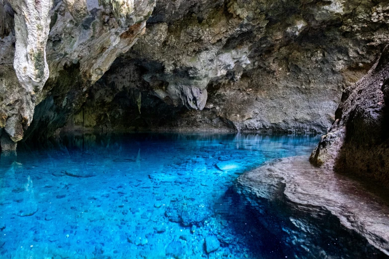 a couple of people walking in a cave