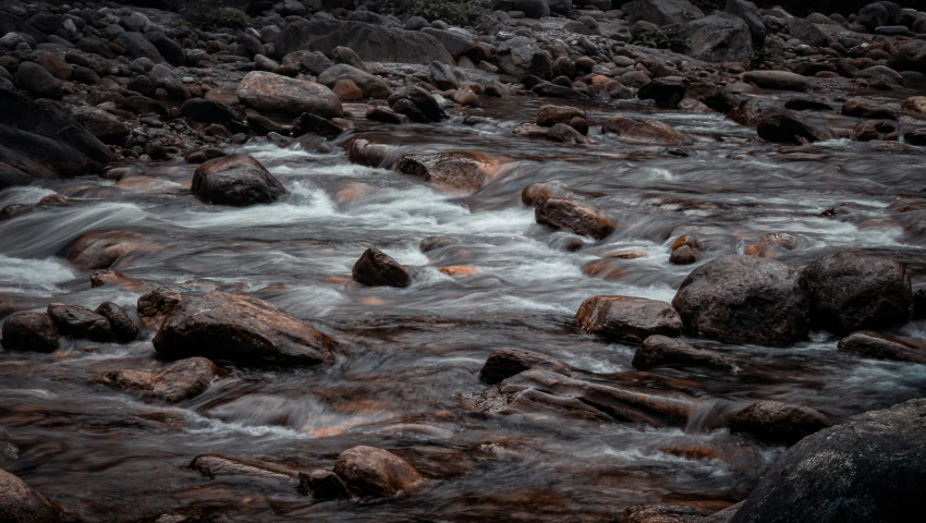 the stream with large rocks running through it