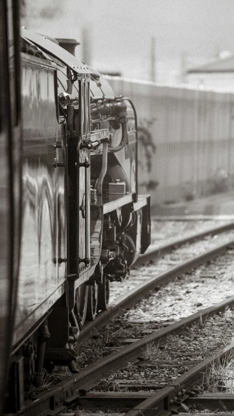 a train on tracks in the snow and fog