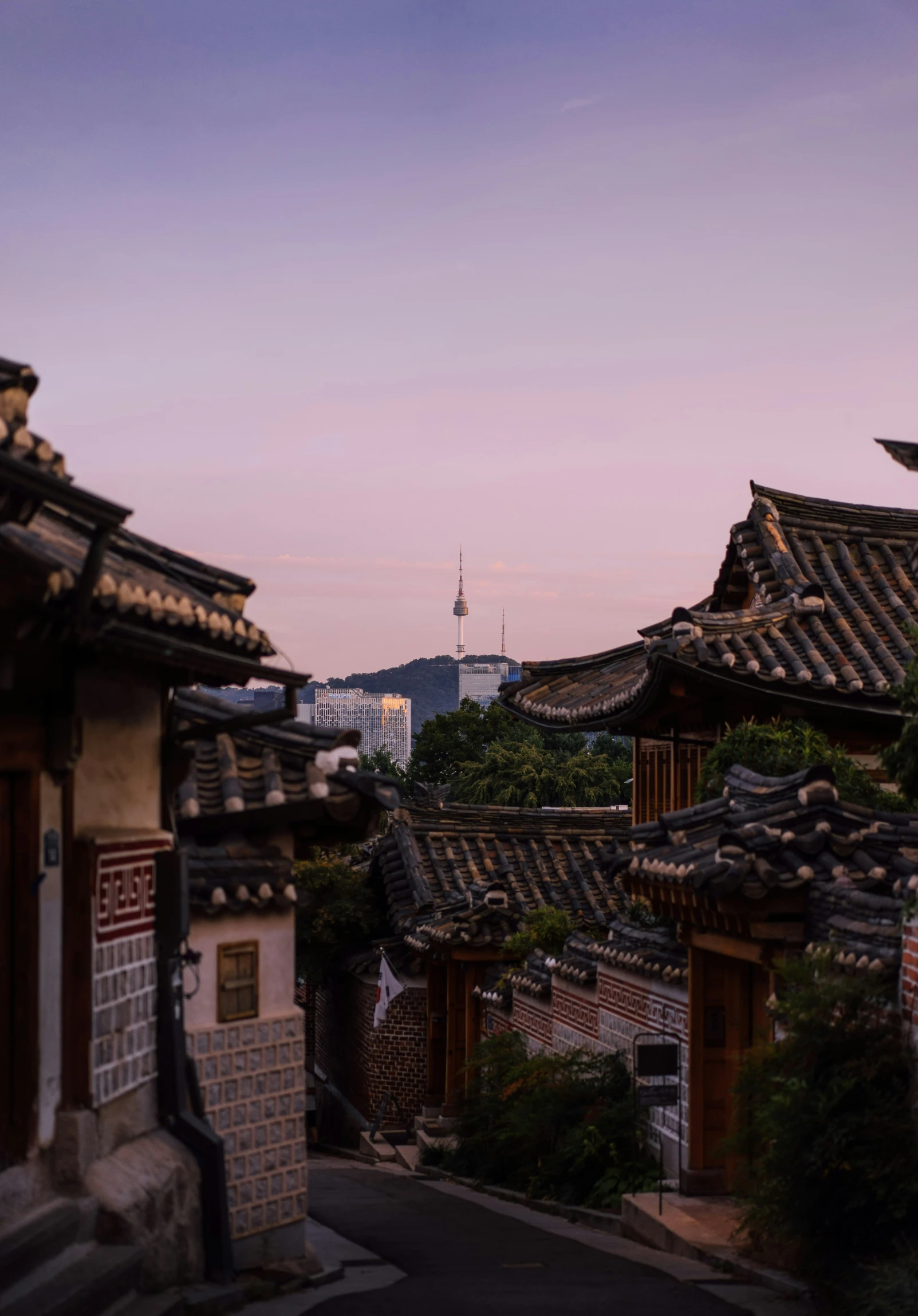 some roofs and buildings with the sky in the background