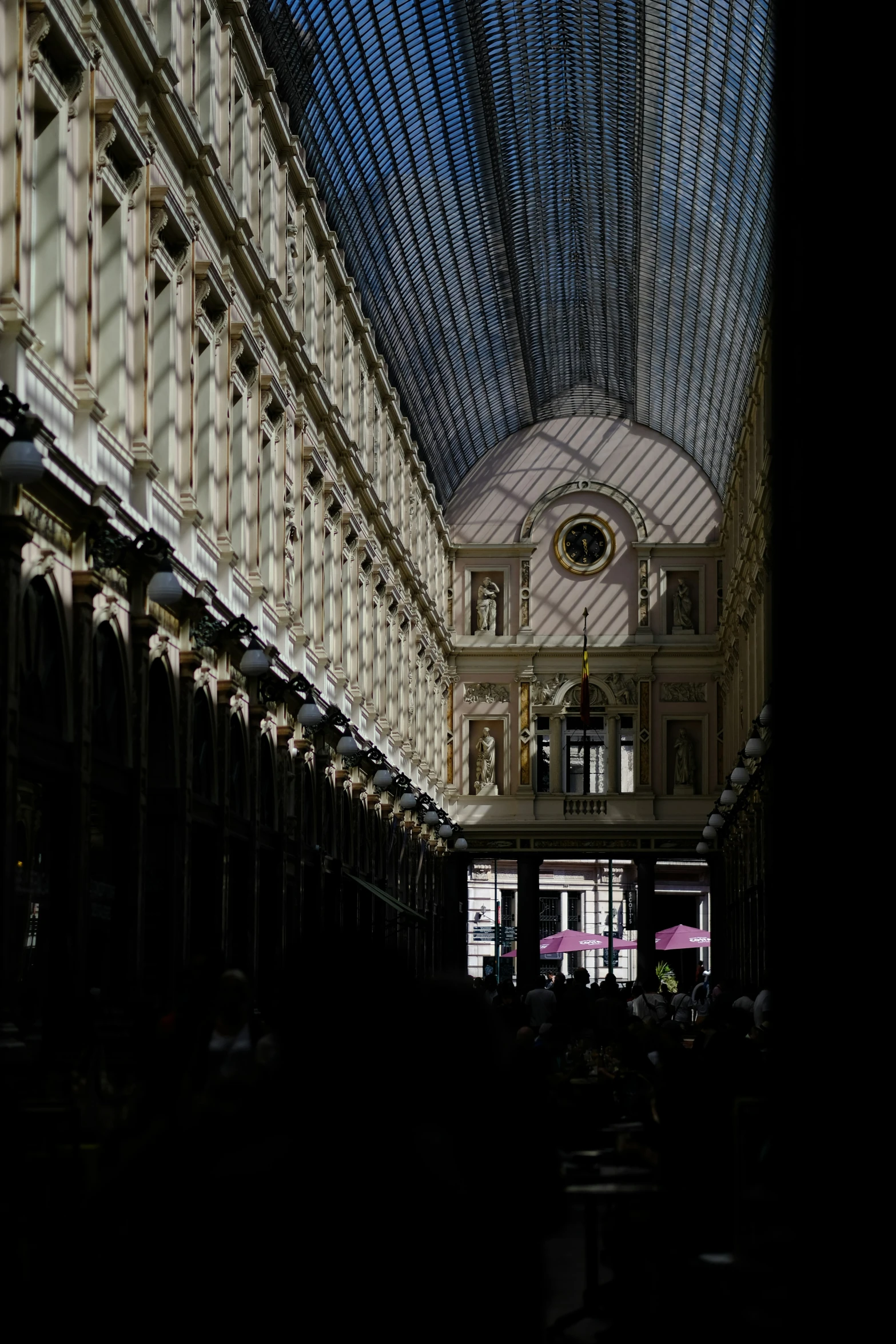 the inside of an indoor train station, lit up by daylight