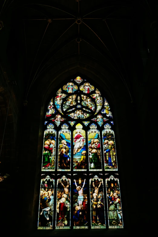 a stained glass window with people standing in it