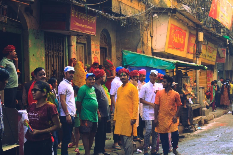 some people standing outside of a store while many are waiting