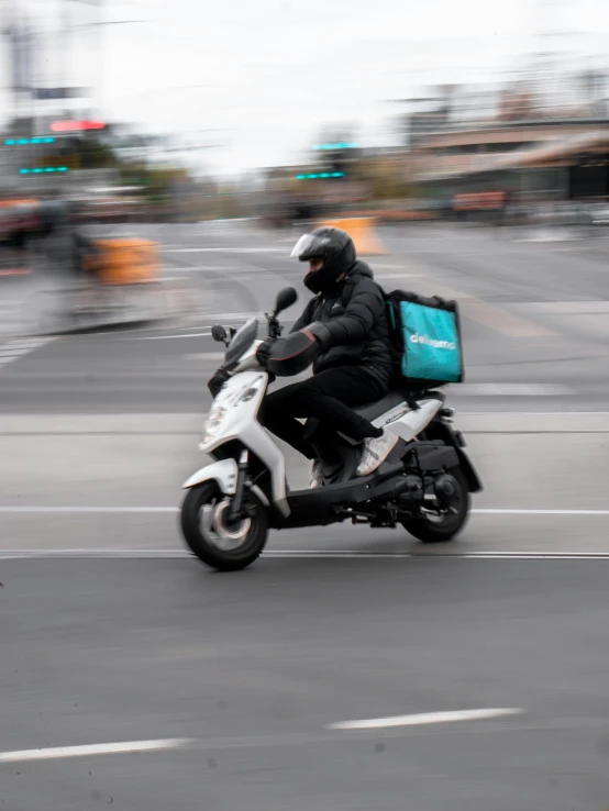 a person on a motorcycle with a suitcase