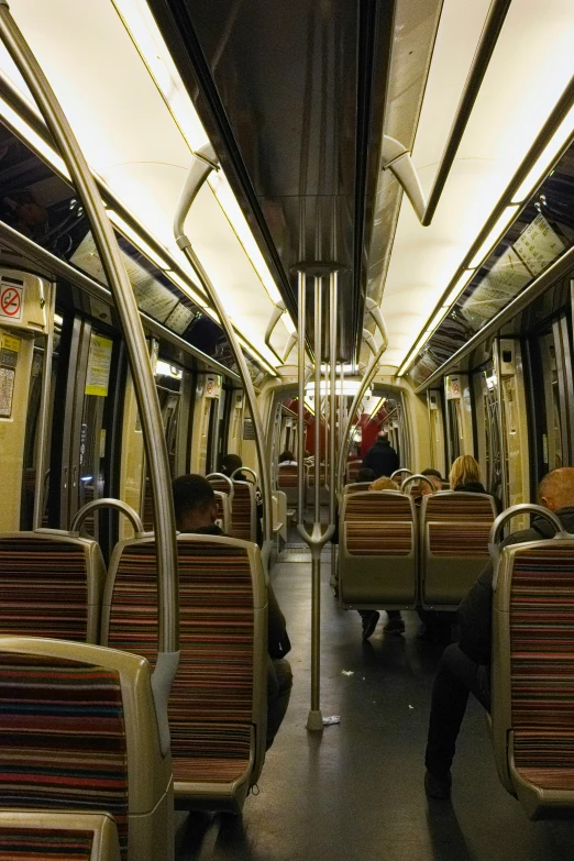 the interior of a commuter train with its lights on