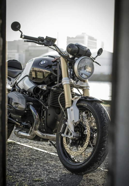 a black motorcycle parked next to a river