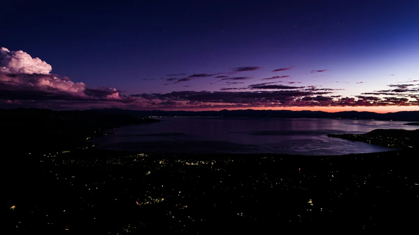 the water is lit up by the night sky