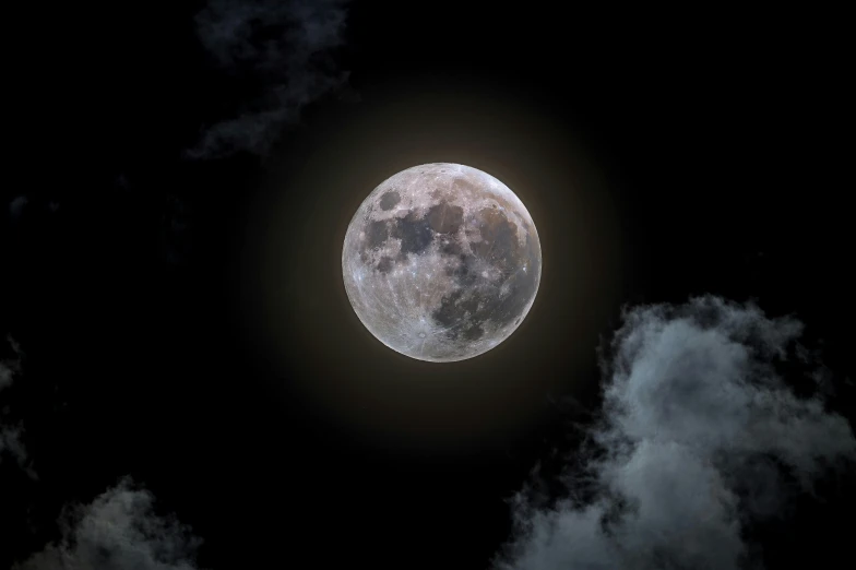the moon is shining through the clouds in this dark sky