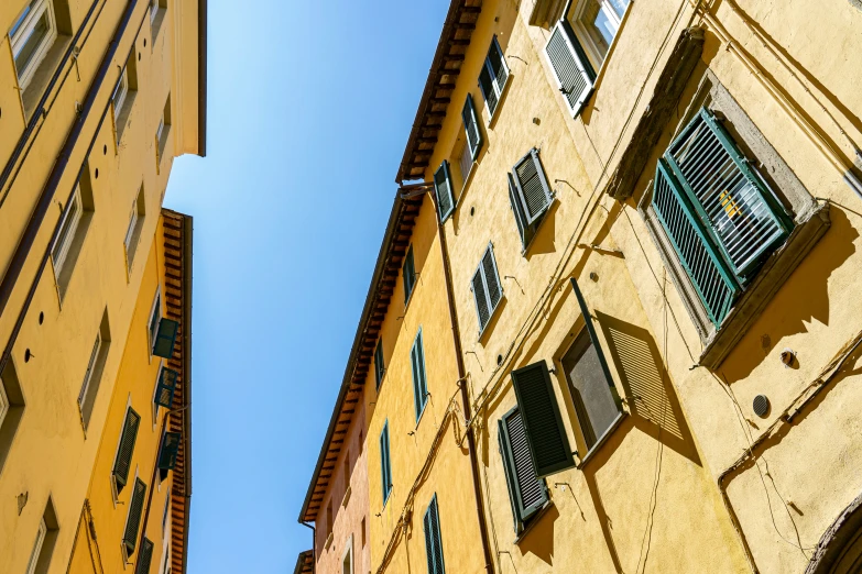 a view up to the side of an apartment building in a town