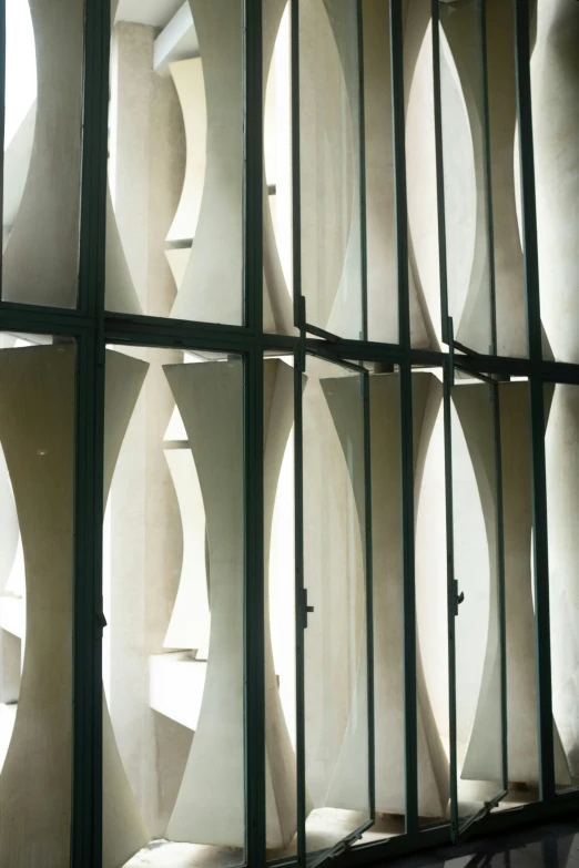 several rounded sections of white painted concrete on the wall