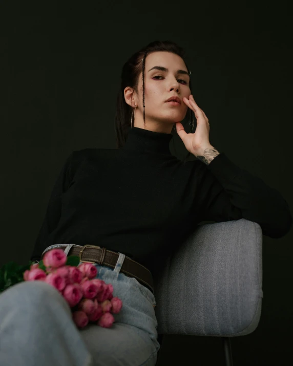 a person sitting down with a bouquet of flowers