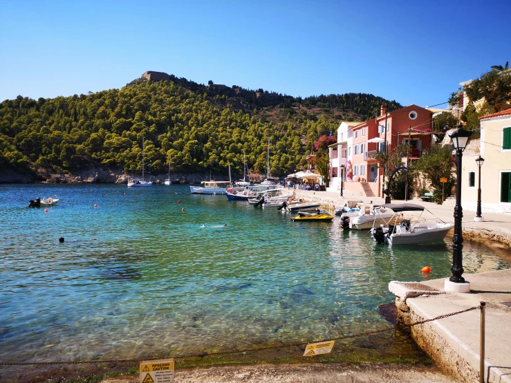 boats are docked in the harbor near a mountainous area