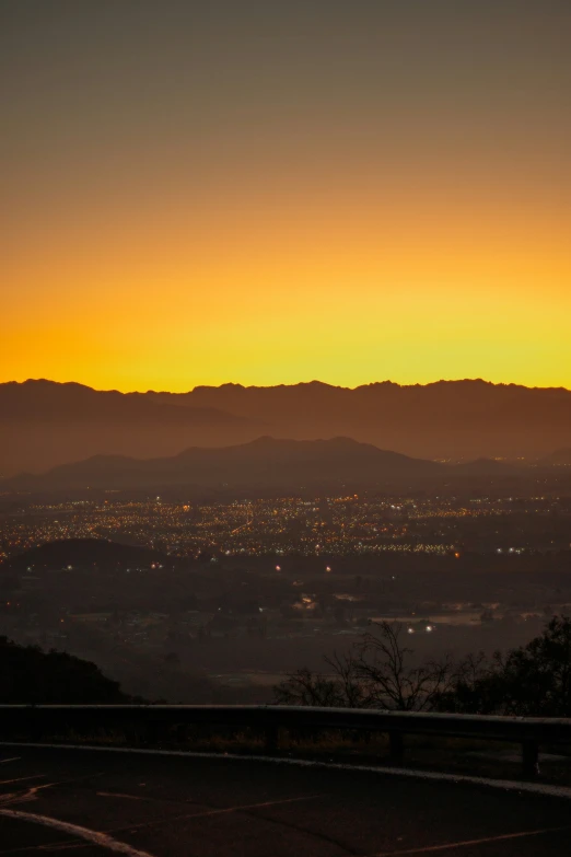 sunset in the middle of mountains on an otherwise dark day