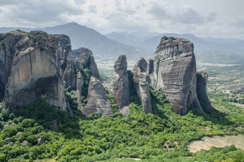 the rocky mountains are bordered by trees and bushes