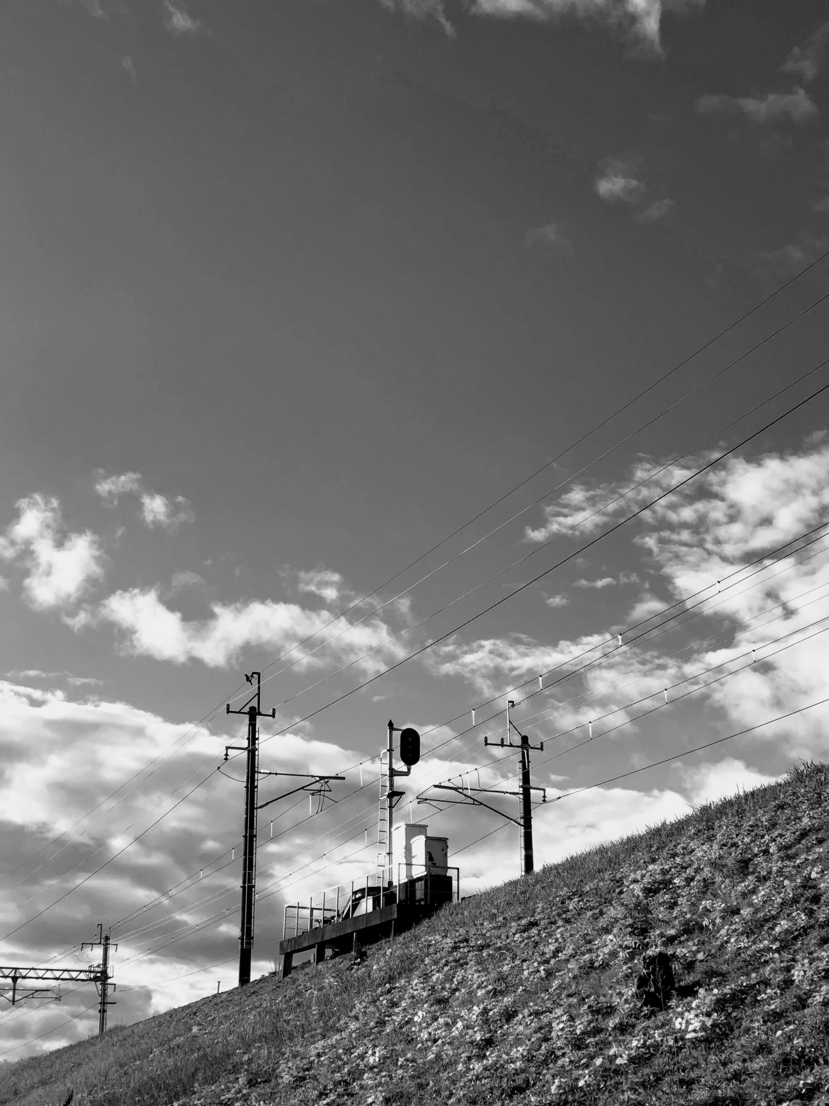 a very tall hill with some power lines on top