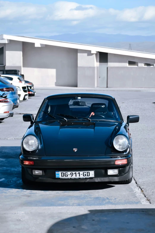 a blue sports car is parked in the parking lot