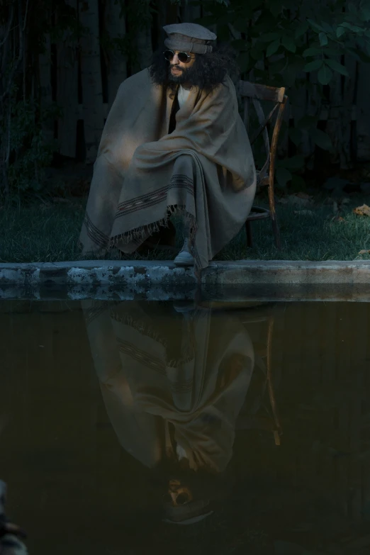 a skeleton sitting on a park bench with a blanket on