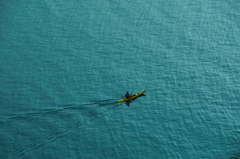 a boat sailing in the middle of a large body of water