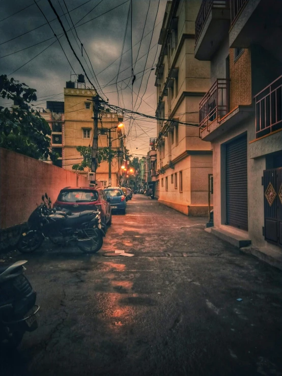 cars on the street near buildings in the rain