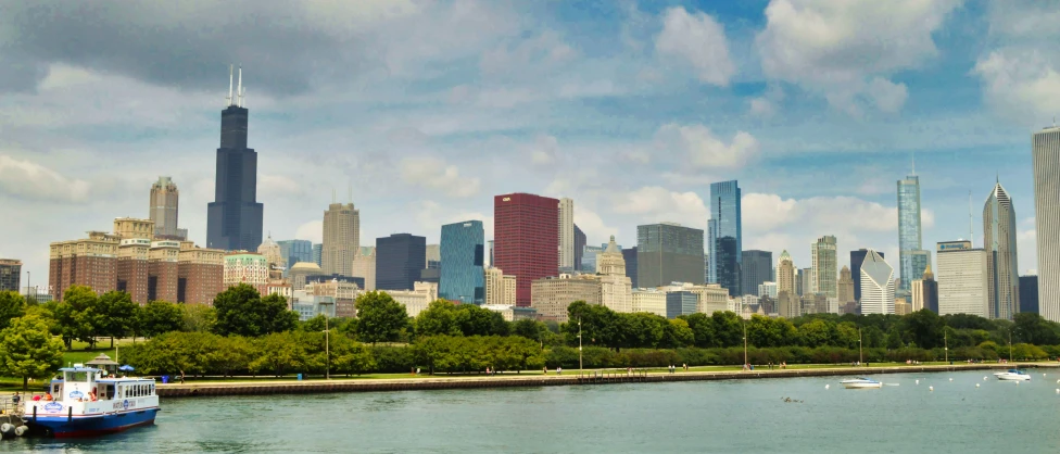 a boat is in the water in front of a city skyline