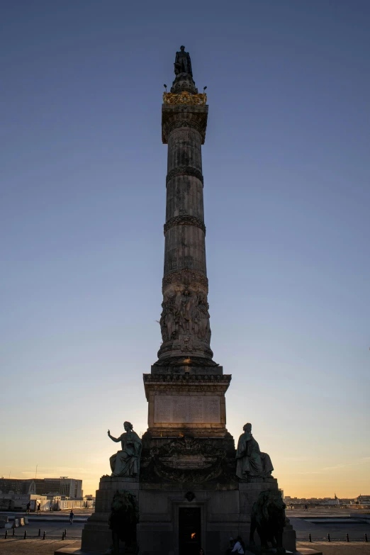 a tall tower with a statue on top of it