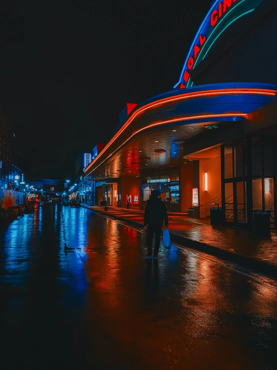 some people walking around on a rainy night