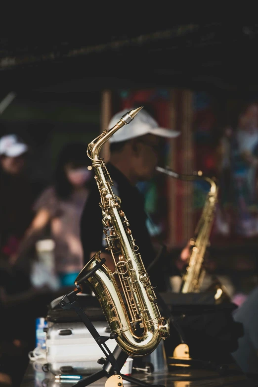 a man playing a saxophone in front of a band