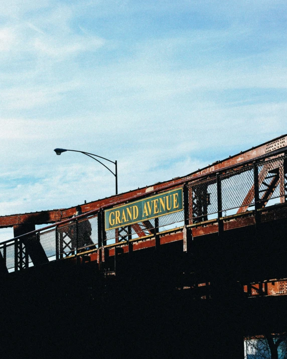 an old bridge sits with the sign grand avenue