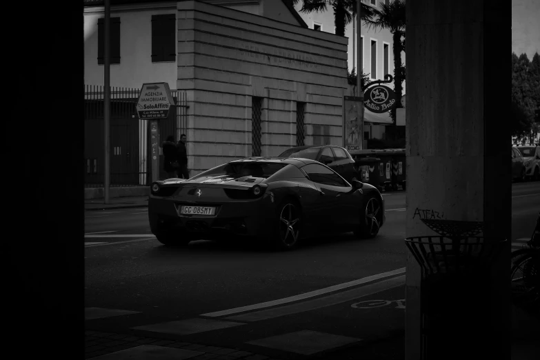 a black sports car is parked near a building