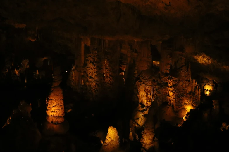 several rocks in a cave at night with lights shining on them