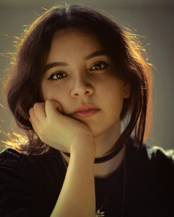 a woman with brown hair posing for a po