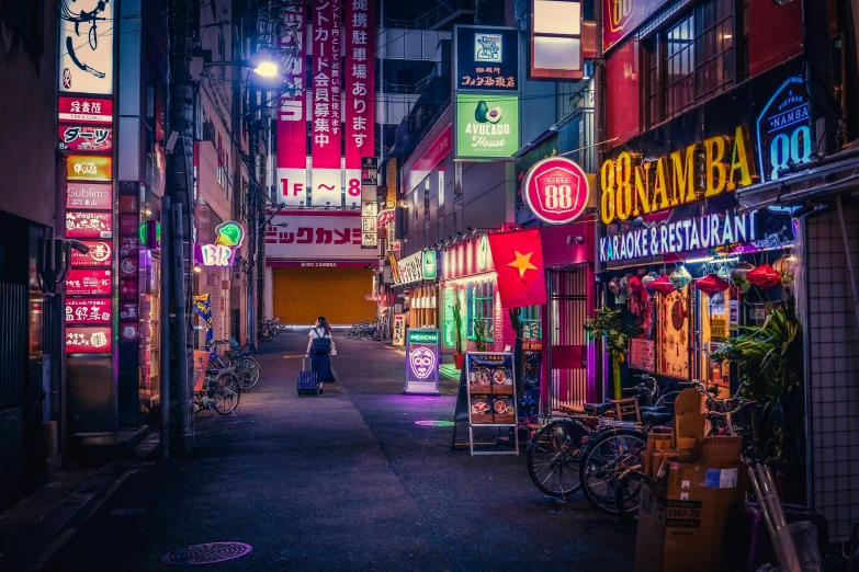 an alley way is lit up with many colorful banners