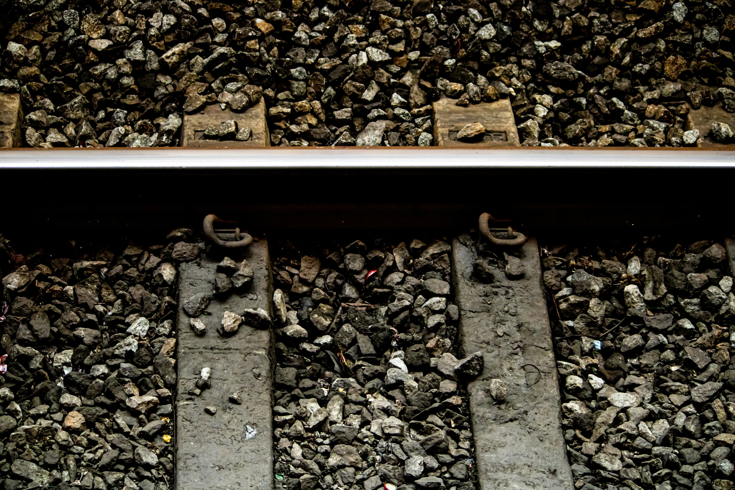 a metal rail leading down to a rocky side