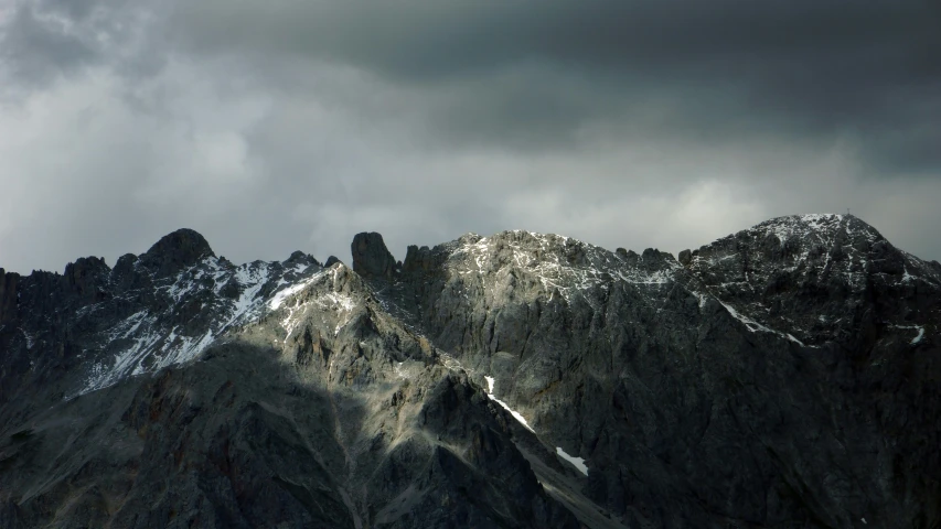 snow covered mountains with a gray sky in the background