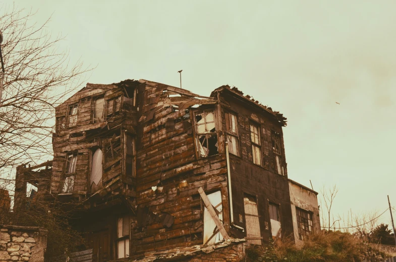 an old, run down house that's been standing in the grass