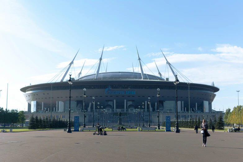 people standing in front of an arena building